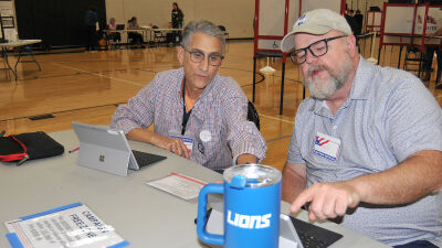  Royal Oak poll workers Kurt Von Eberstein, left, and Ed O'Sullivan wait for voters to arrive at Royal Oak High School Nov. 5. 