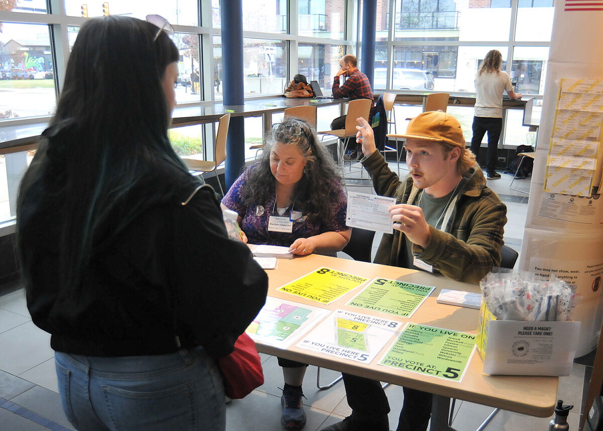  Michele Podzikowski and Cael Tanner assist a voter at the Ferndale Area District Library Nov. 5.  