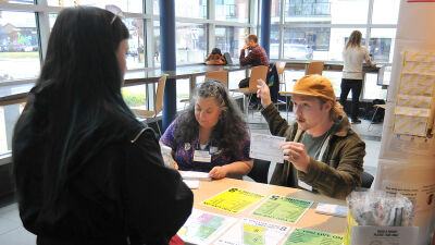  Michele Podzikowski and Cael Tanner assist a voter at the Ferndale Area District Library Nov. 5.  