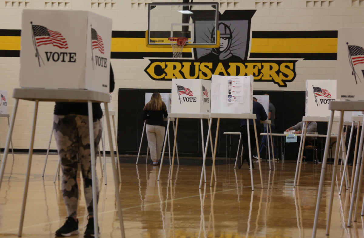  Voters mark and cast ballots inside the L’Anse Creuse Middle School North gym on Nov. 5.  