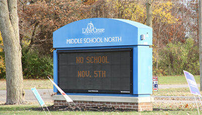  Campaign signs surround the L’Anse Creuse Middle School North marquee sign on Nov. 5. 