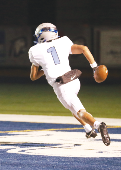  Utica Eisenhower junior Braylon Burnside does a lap around the endzone after returning an interception for a touchdown on the first play of the game. 