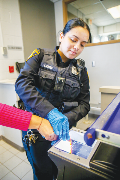  Birmingham Police Officer Luxie Kouza demonstrates a fingerprint scanner, a device used for the VIP program. 