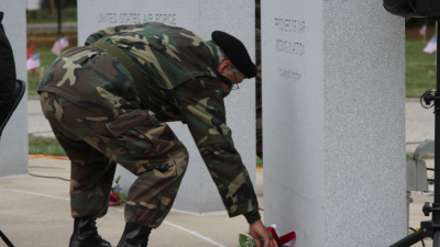  U.S. Army veteran John Adams places a bouquet of flowers at the base of one of the tablets at the American Veterans Memorial. The ceremony was part of a Veterans Day event at Resurrection Cemetery on Nov. 11. Adams is part of Vietnam Veterans of America Chapter 154’s color guard. 