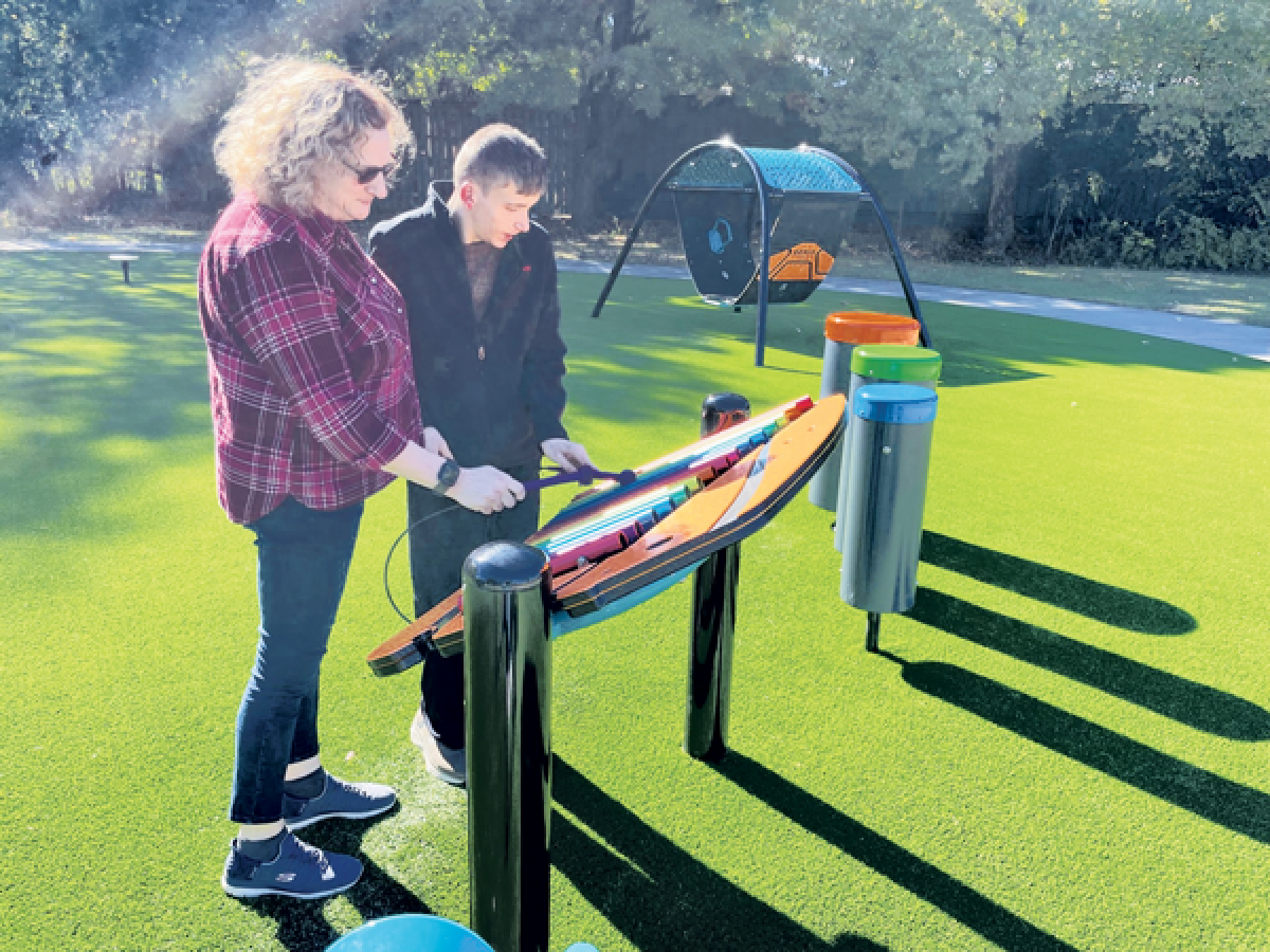  Kari Norton and her son, Gabe, play on the musical equipment at Memorial Grove. 