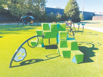  Memorial Grove features new interactive play equipment with a turf floor around the existing walkways. 