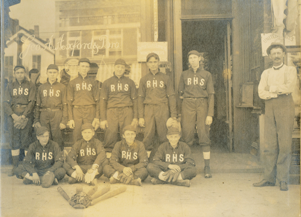  The 1911 Rochester High School baseball team with George Axford,  right, in front of his store. 