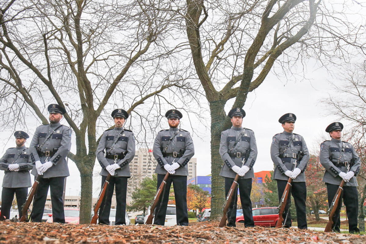  Members of the Troy Police Honor Guard stand at attention outside the front of Troy City Hall for the city’s Veterans Day ceremony. 