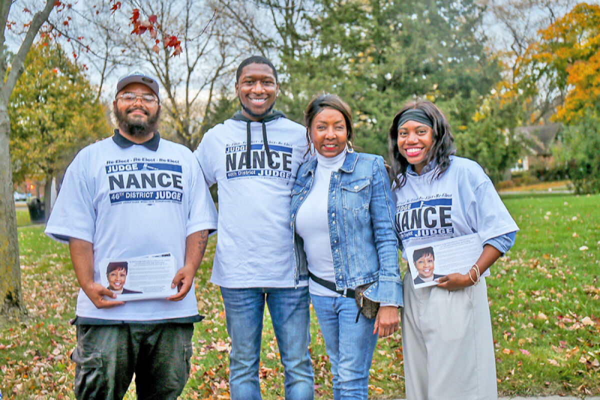  Debra Nance, 46th District Court judge, stands with volunteer canvassers at Lathrup Village City Hall on Election Day. 