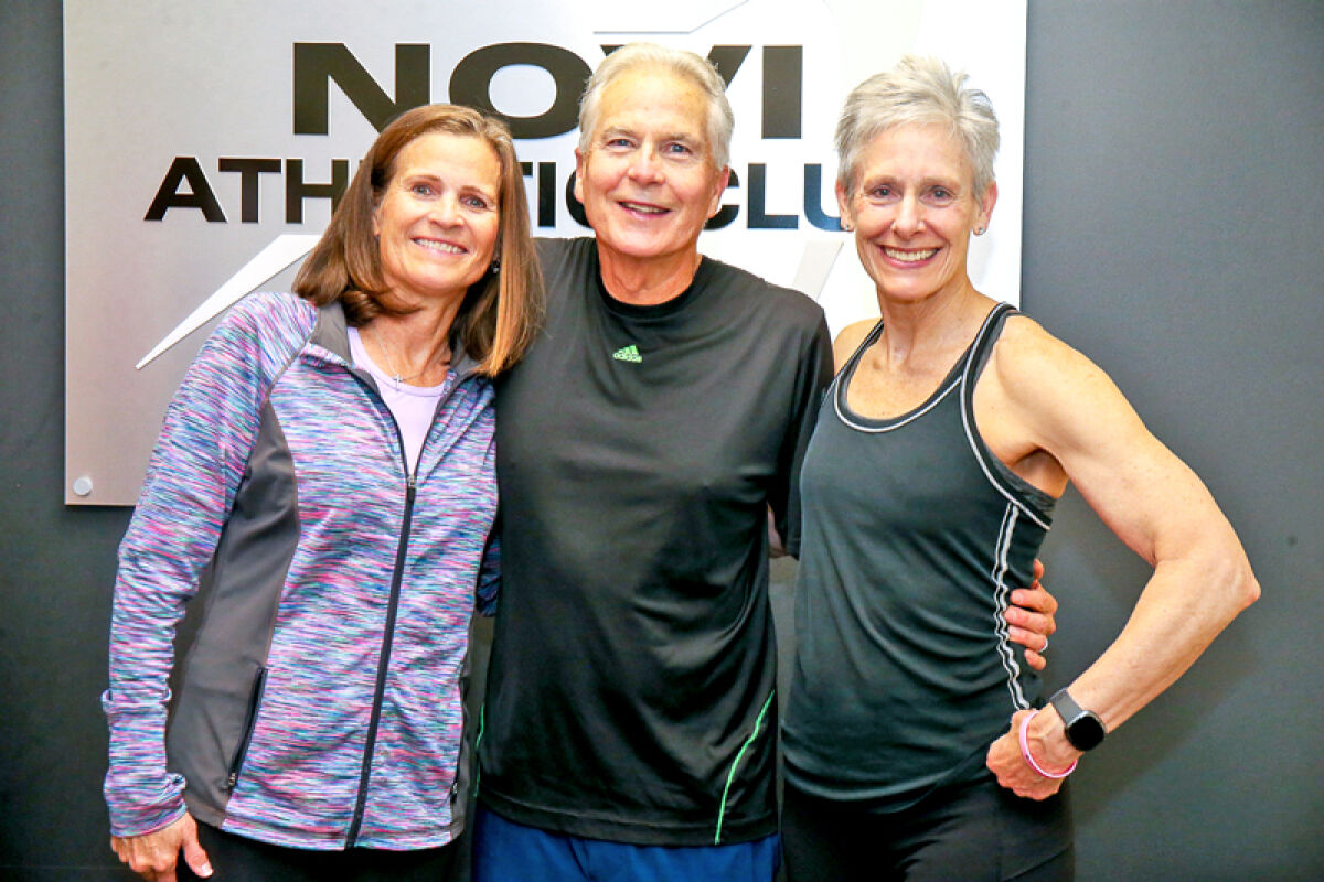  Chuck Ross poses for a picture with his wife, Cathy, and fitness coordinator Kim Taylor-Papp, right, who saved his life when he suffered a heart-attack Oct. 17 at the Novi Athletic Club. 