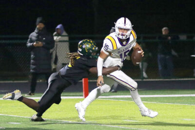  A Birmingham Groves defender goes after Warren De La Salle senior quarterback Sante Gasperoni. 