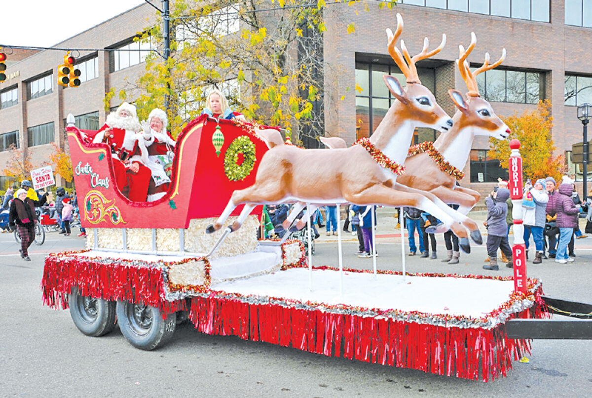  Santa and Mrs. Claus are pulled through downtown Mount Clemens during a previous parade. 