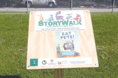  One of the Story Walk signposts is installed at United Oaks Elementary School in Hazel Park. Each signpost features a page from a children’s book, along with interactive prompts. 