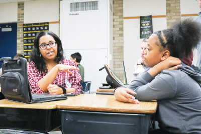  Rachel Dearing, communications specialist with the Macomb County Department of Planning and Economic Development’s marketing and communications team, left, discusses the project with sixth grader Lauren Turner on Nov. 14. 