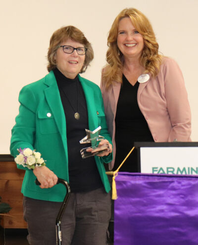  Megan Saunders, left, is presented with the “Senior Extraordinaire” award by Dr. Kelly Coffin, interim superintendent of Farmington Public Schools, on Oct. 17. 