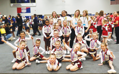  The Rochester Raiders junior freshman cheerleading team celebrates a first-place finish at MYFCC’s Super Cheer Oct. 26 at Madonna University. 