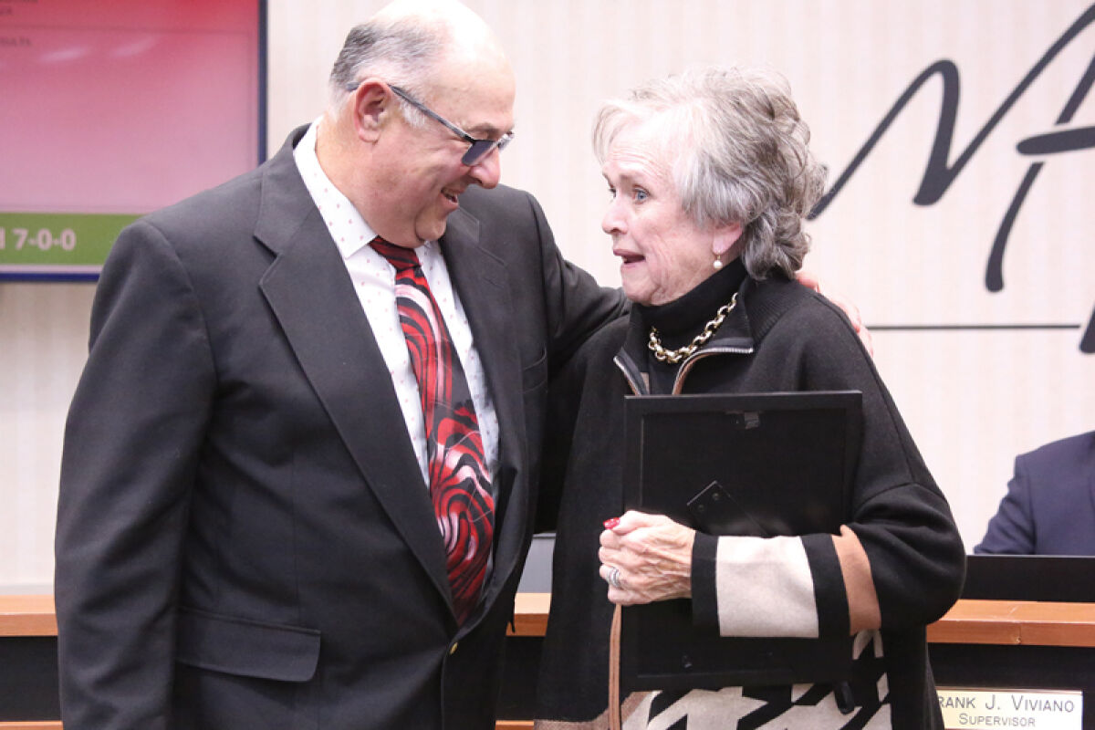  Outgoing Macomb Township Trustee Nancy Nevers, right, speaks with Trustee Charlie Oliver after the Nov. 13 Macomb Township Board of Trustees meeting. 