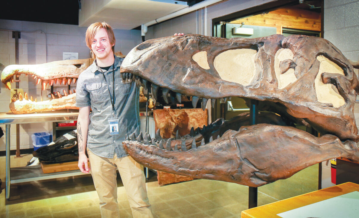  Timothy Urban, program presenter and dinosaur enthusiast, with a T. rex skull at Cranbrook Institute of Science. 