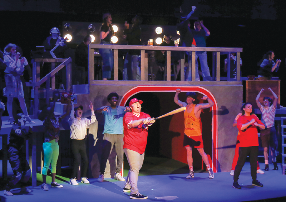  Isaac McFadden, center, stars as Pete Rose alongside other members of the show’s cast during the dress rehearsal of OCC’s production of the brand-new musical “Charlie Hu$tle” Nov. 13. 