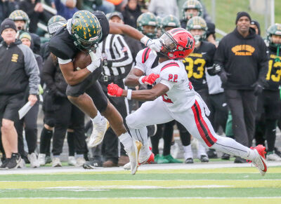  Birmingham Groves senior running back Noah Sanders stiff-arms a OLSM defender. 