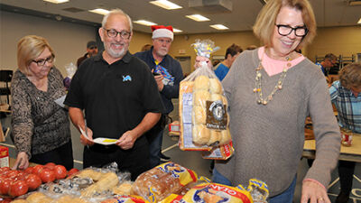  Volunteers pick out items for Thanksgiving baskets. Each family received three large boxes of food to last one week in addition to the full Thnaksgiving dinner. 