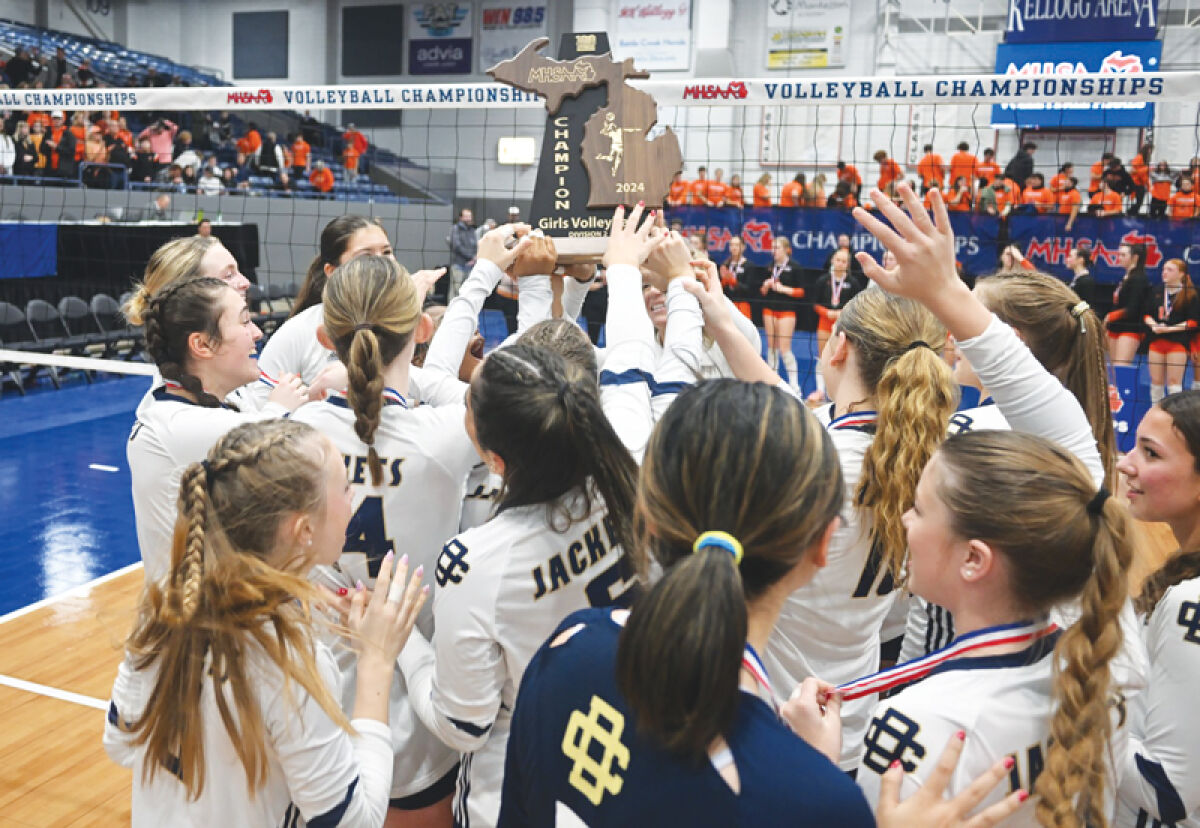  Detroit Country Day celebrates winning the school’s first-ever state championship title in a 3-0 win over Tecumseh Nov. 23 at Kellogg Arena in Battle Creek. 