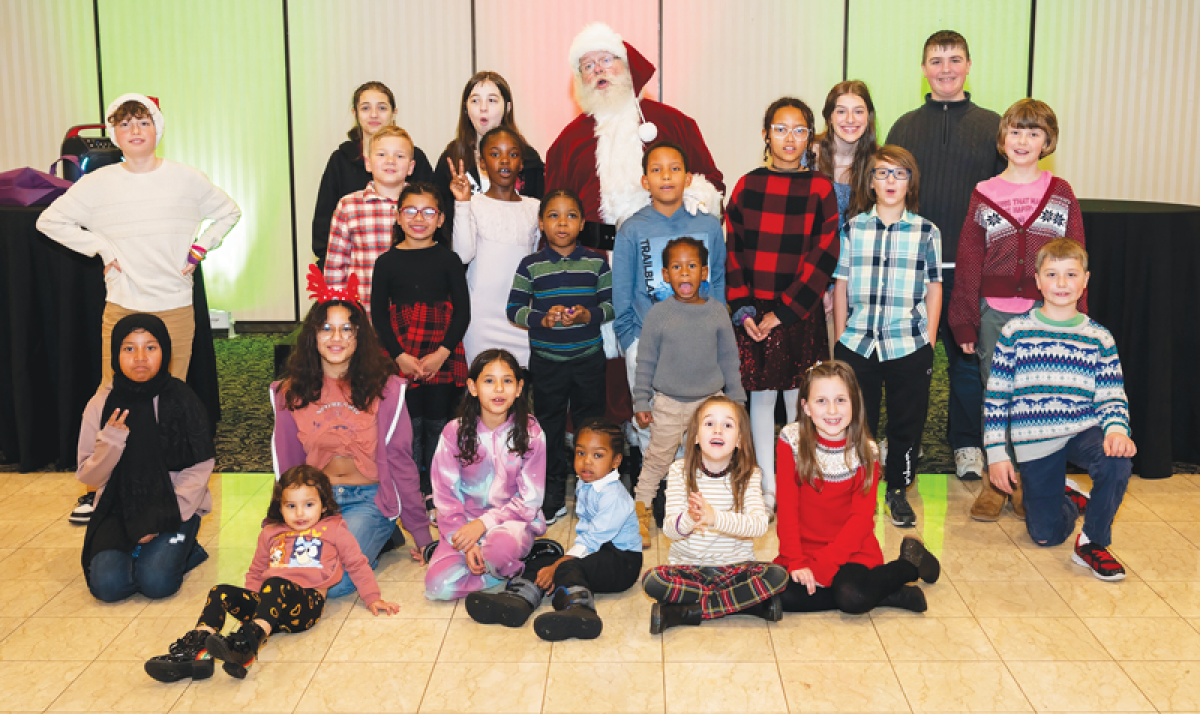  Kids from a previous Adopt-a-Family brunch, put on by the Butterfly Collective, pose for a photo with Santa. 