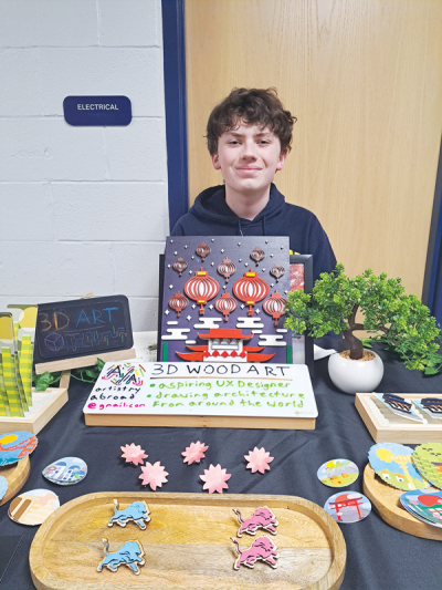  Dylan Kuna, 14, sells his artwork at the East Middle School craft show on Nov. 23. 