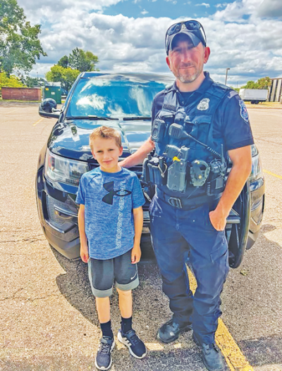  Officer Nick Kott stands with his son, Jack.  