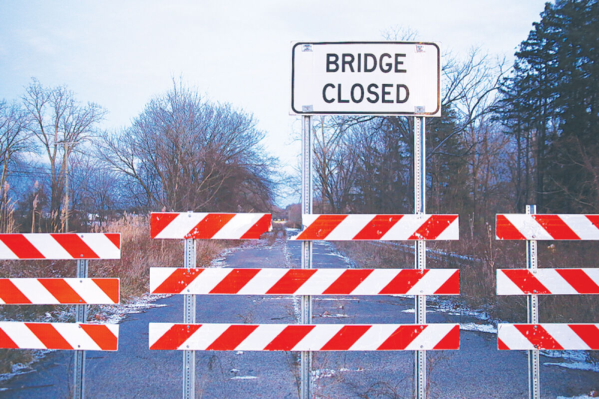  Barriers block traffic from passing the 25 Mile Road bridge over the North Branch Clinton River. Funding for a planned 2024 replacement project has been delayed. 