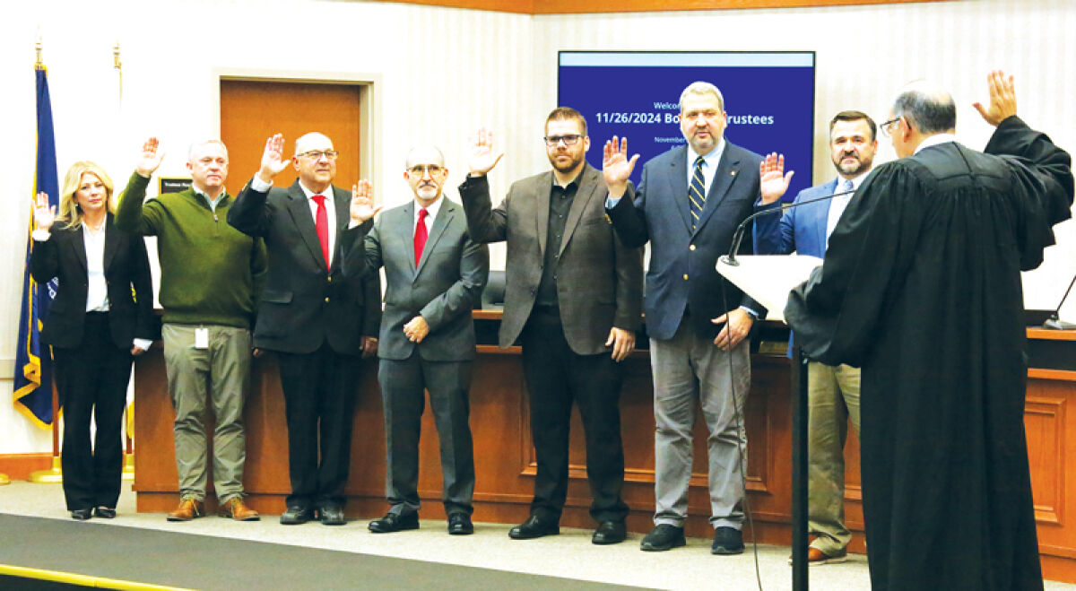  Members of the Macomb Township Board of Trustees are sworn in by Michigan Supreme Court Justice David Viviano before the Nov. 26 board meeting. 