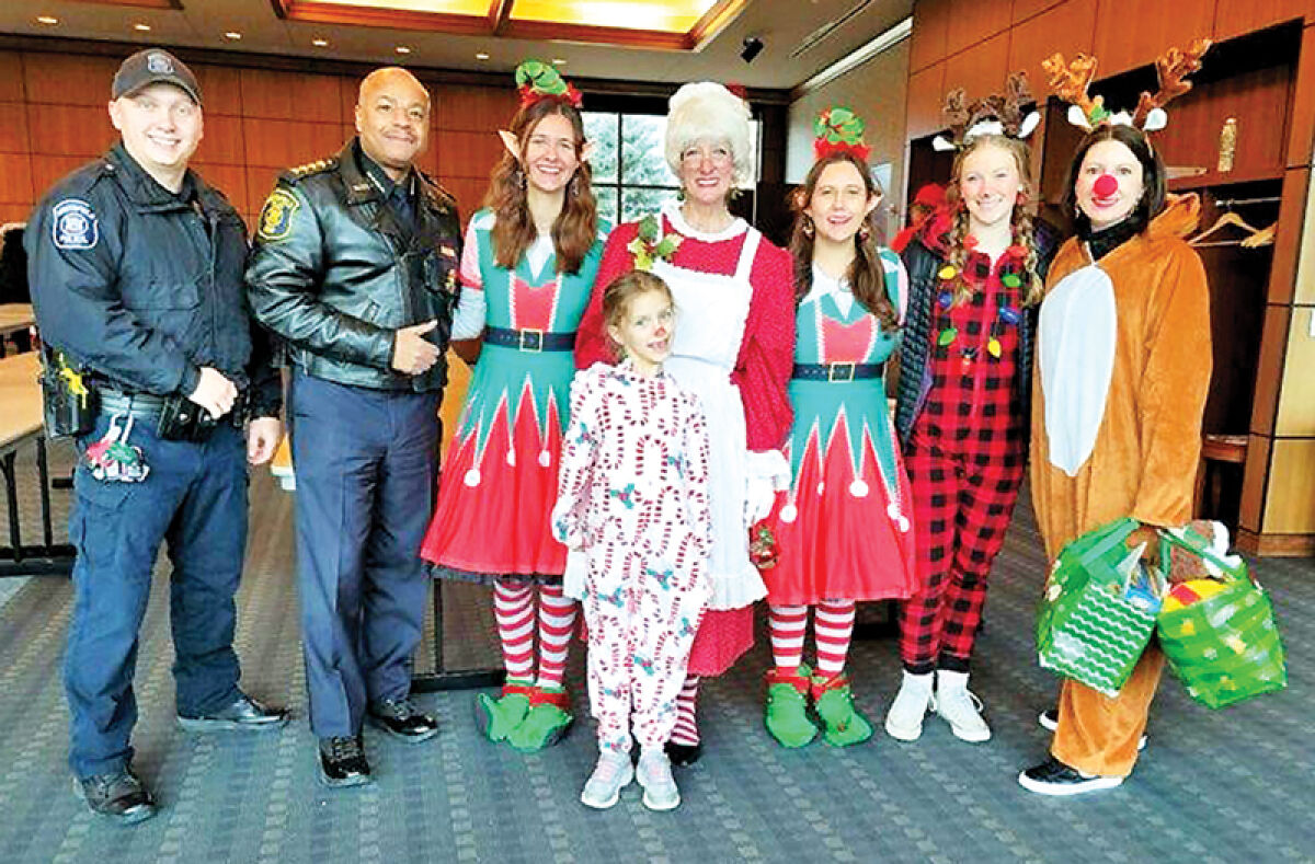  Southfield Police Chief Elvin Barren, second from left, poses with the festive Southfield Police Department at last year’s Holiday Sleigh of Giving event. 