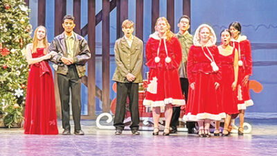  The Troy Theatre Ensemble performs the finale of “White Christmas” for their upcoming performances at Troy High School. 