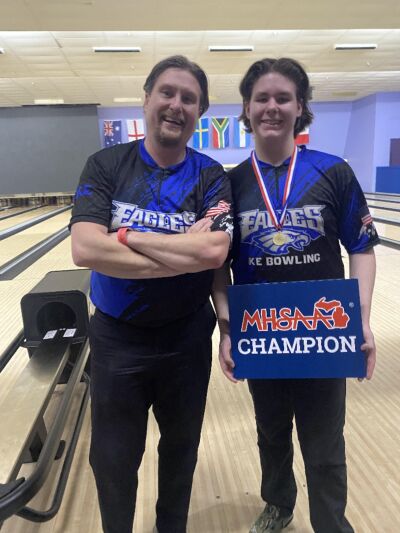  Utica Eisenhower senior Dylan Harnden celebrates winning the MHSAA Division 1 individual state championship with his head coach — and father — Mark Harnden. 