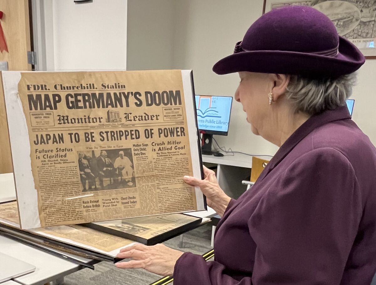  Local historian Beverly Bishop holds up a copy of the Daily Monitor Leader newspaper from December 1943. The photo on the front page features a photo of Chinese leader Chiang Kai-shek, U.S. President Franklin Delano Roosevelt and British Prime Minister Winston Churchill. 