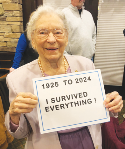  Jean Moeller celebrates her 99th birthday in style at Hamlin Pub in Shelby Township. Moeller holds up a fun sign for the camera. 