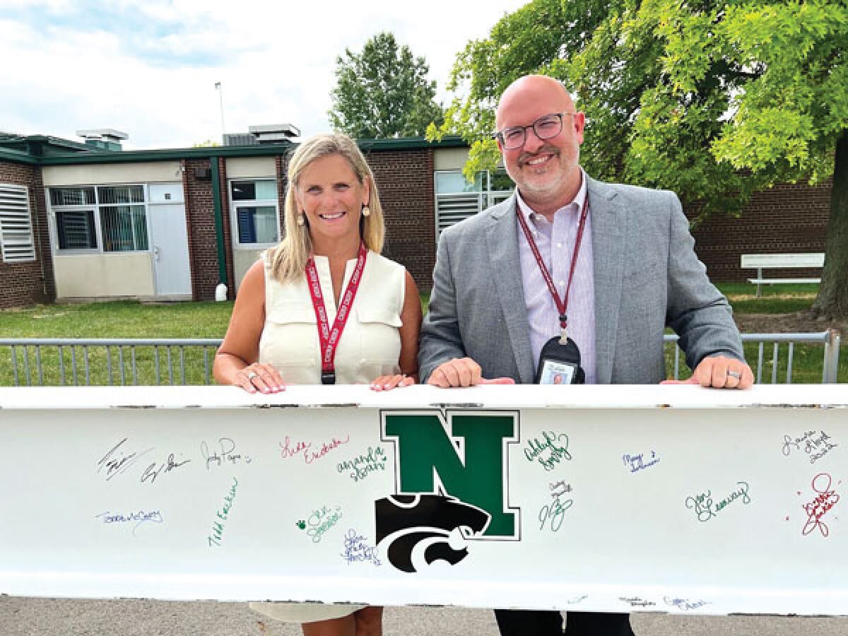  Lisa Fenchel and John Brickey, sixth and fifth grade principals at Novi Meadows Elementary School, respectively, pose with a beam that staff recently signed. The beam will be placed above the office in the new Novi Meadows Elementary School building, which is scheduled to open for all fifth and sixth grade students in the fall of 2024. 