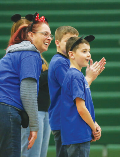  Christina Tudor, of Farmington, watches as her son, Henry, 8, who has cystic fibrosis, learns Dec. 12 that he is going to go to Walt Disney World thanks to the students at Novi High School and Make-A-Wish Michigan. 