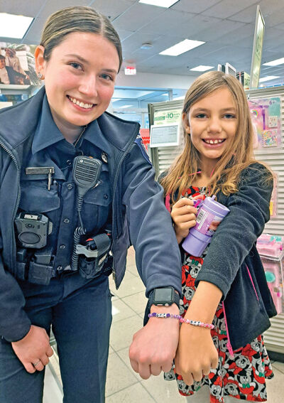  Novi police officer Kaleigh Thompson and her new best friend forever Abby Thompson — no relation — show their matching “BFF” bracelets that they purchased during the event. 