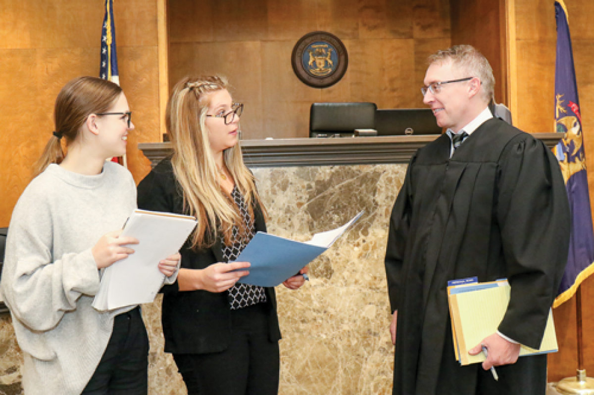  Judge Brian Hartwell of the 43rd District Court in Hazel Park discusses the new treatment court with Bella Koepp —  the program’s case manager — and Jessica Godwin, the court’s chief probation officer and program coordinator. The treatment court helps rehabilitate individuals struggling with addiction to drugs and alcohol. 