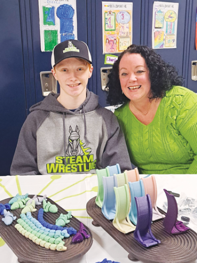  Andrew Rathe, 14, and his mom, Jennifer, sell his homemade fidget toys, to benefit CARES  of Farmington Hills, at the Lanigan  Elementary Craft Show on Dec. 14.  