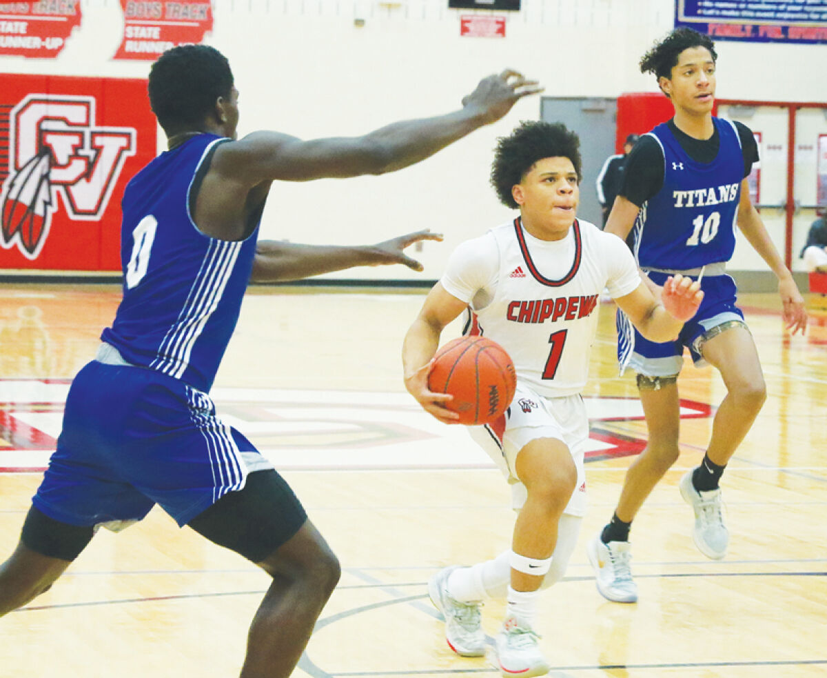  Clinton Township Chippewa Valley junior Joshua Johnson drives to the basket against Warren Woods Tower Dec. 26 at Chippewa Valley High School. 