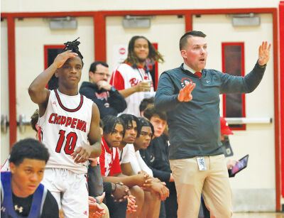  Clinton Township Chippewa Valley head coach Corey Smith communicates with his team. 