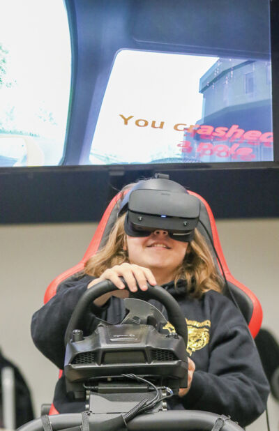  Clintondale junior Andrew Koltvedt uses the drunken driving simulator at the International Save a Life Tour’s Dec. 12 event. 