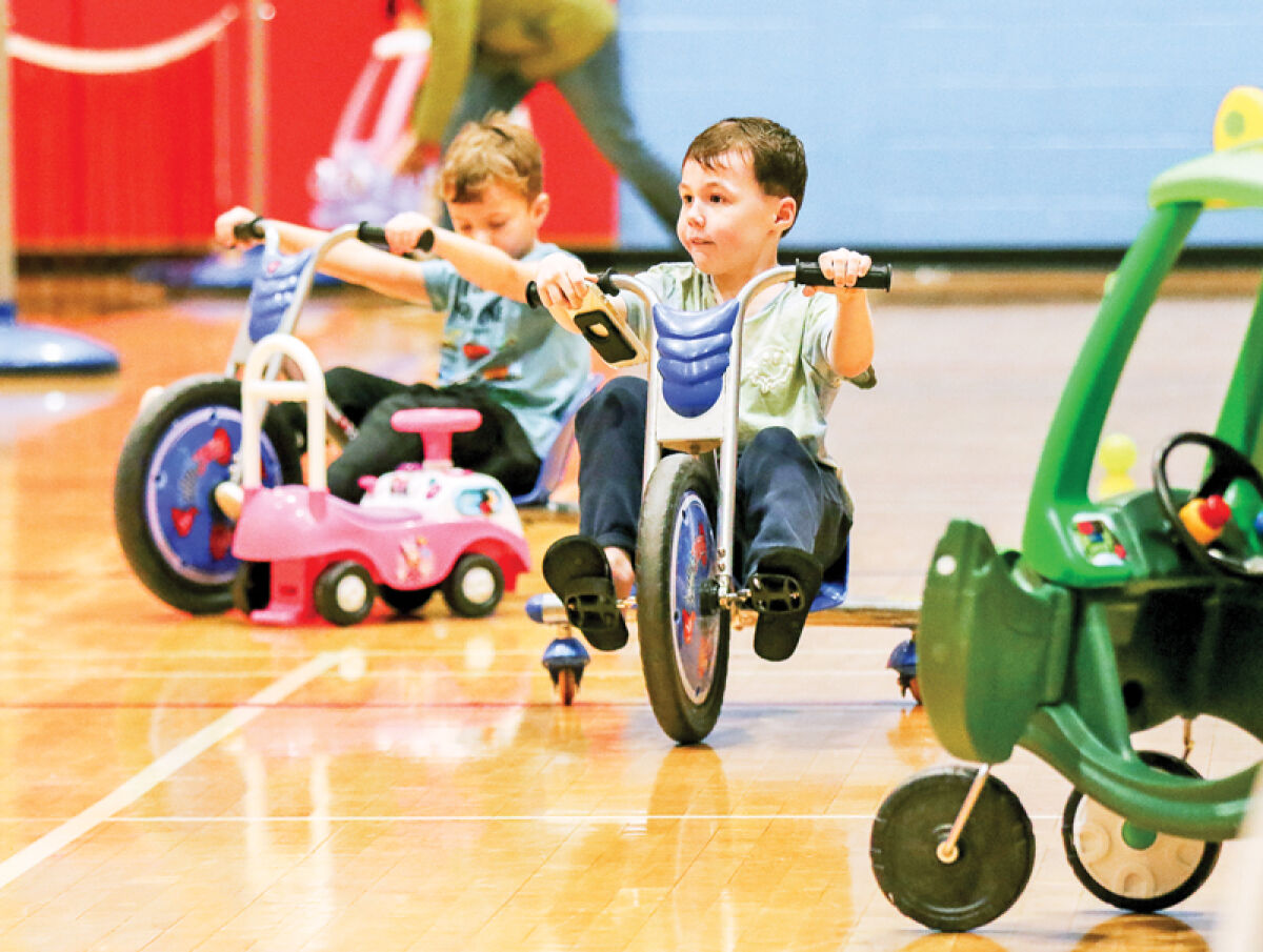  At the Troy Community Center, young visitors enjoy some of the various scooters and toys available during the center’s New Year’s Day Out event. 