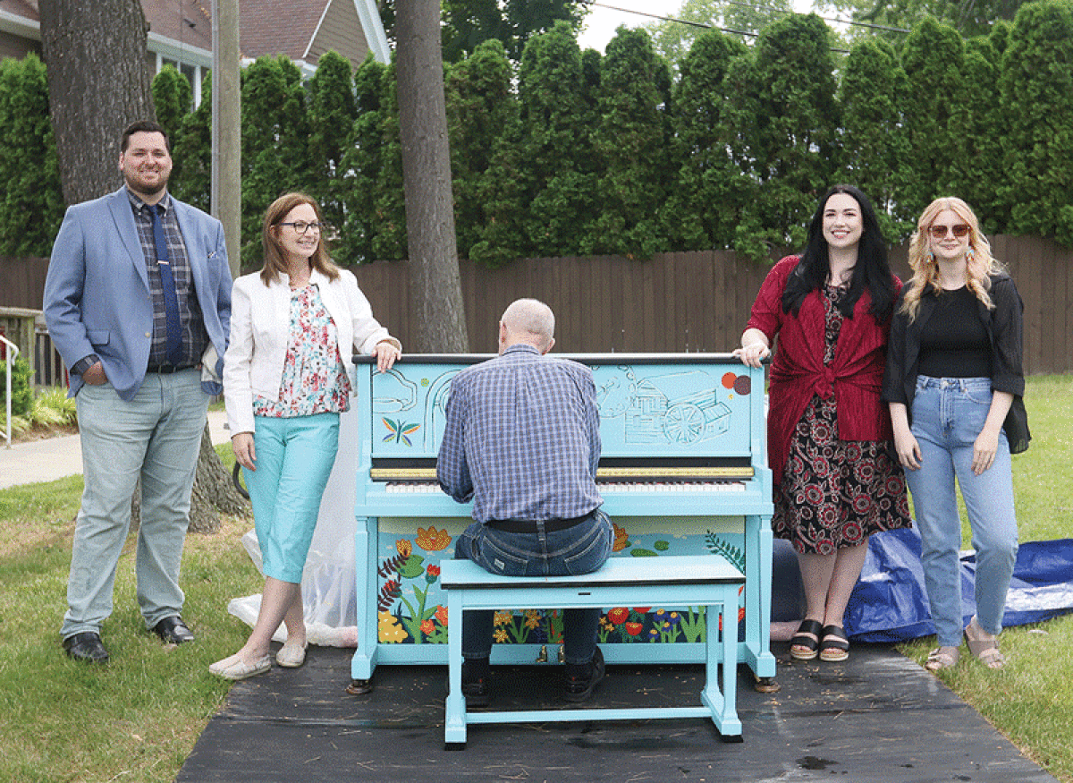  Shaun Hayes, left, the executive director of the Paint Creek Center for the Arts; Jeanne Barrett, the founding director of Music Shapes; Alana Stultz, the PCCA’s community engagement coordinator; and Lisa Brandt, an artist who designed the piano; along with Scott Blackett, the manager of the Piano Place, unveil the “Kaleidoscope Keys” street piano to the community June 8.  