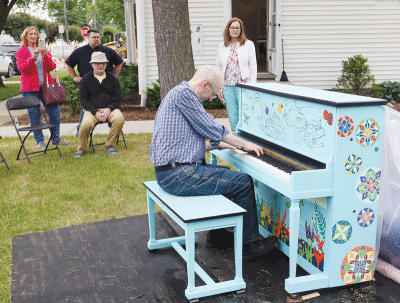  Scott Blackett, the manager of Piano Place, performs on the new outdoor community piano. 