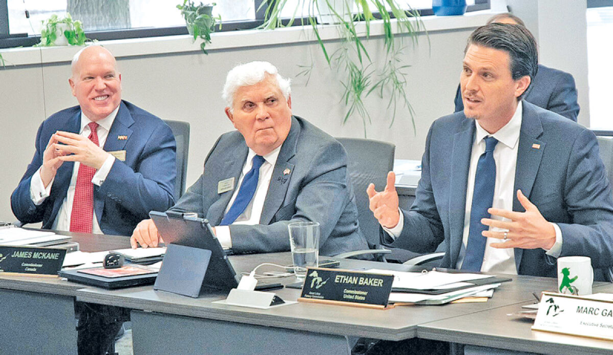  Great Lakes Fishery Commission Chair Ethan Baker speaks on a topic during the commission’s interim meeting while Commissioner Earl Provost, left, and Commissioner Jim McKane, center, listen intently. 