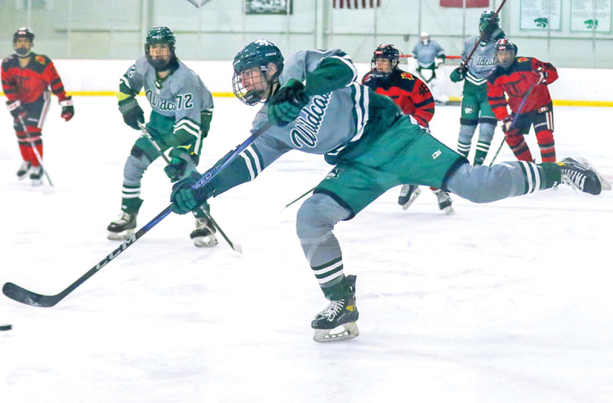  Novi senior Colin Tunney fires a shot during a matchup against Troy United Dec. 20 at Novi Ice Arena. Novi won 9-1. 