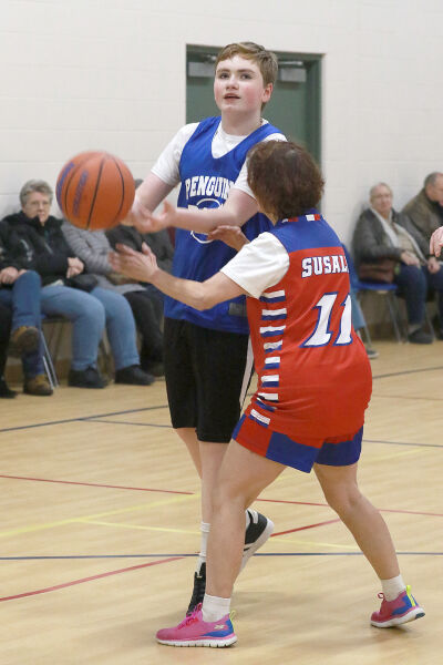  RARE Penguins No. 7 Mason Baerman and Shelby Pistons No. 11 Michelle Susalla show their basketball skills during the game.  